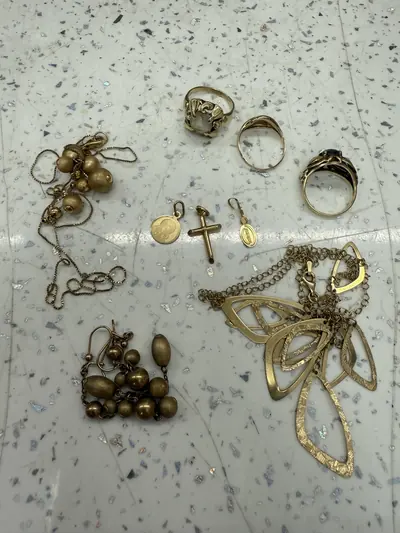 Rings, chains and small jewellery items laid out on a work surface