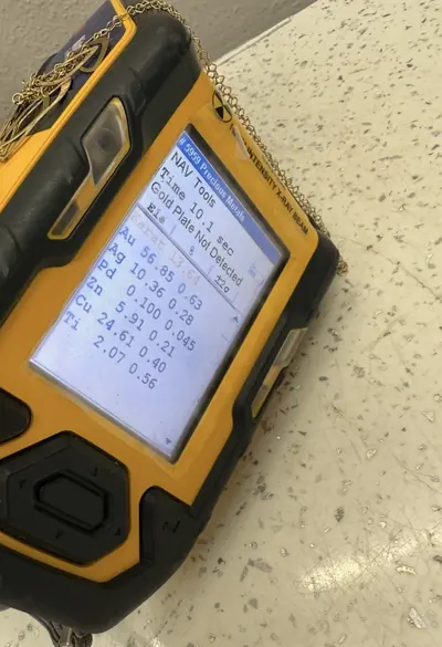 A handheld XRF analyser on a work surface